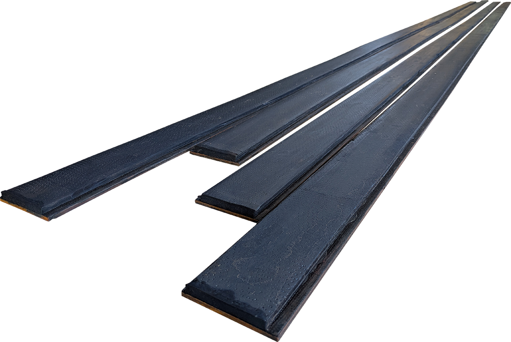 Long strips of rubber bonded to steel backing.